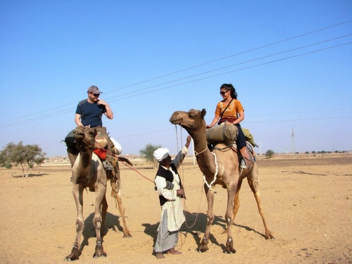 Jaisalmer camel safari - Graham and Shareen heading off into the desert on camels