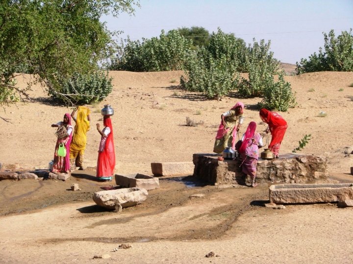 Jaisalmer camel safari - village women filling up on water at a well