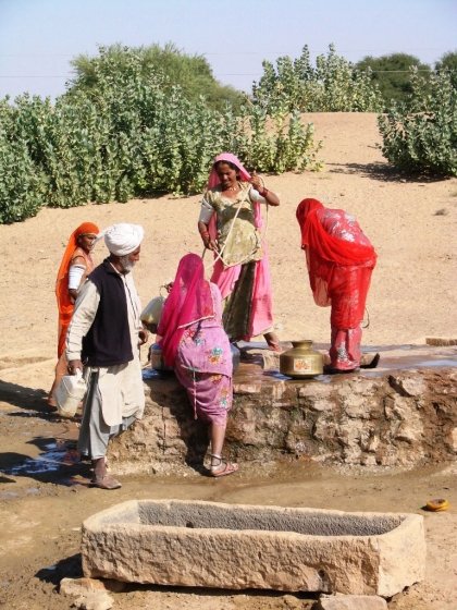 Jaisalmer camel safari - our guide talks to village women at a well